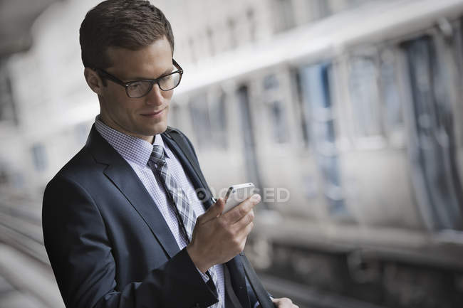 Businessman checking his phone. — Stock Photo