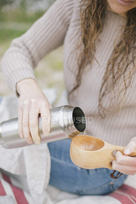 Woman pouring drink — Stock Photo