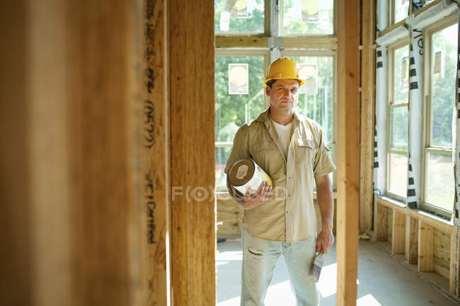 Man standing with paint can in hands — Stock Photo