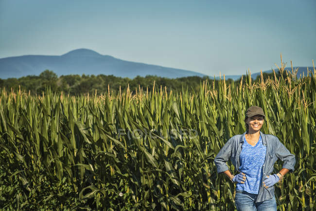 Woman standing beside the stalks. — Stock Photo