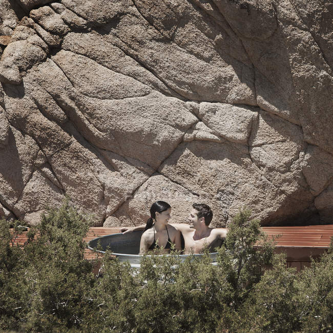 Couple in a sunken hot tub. — Stock Photo