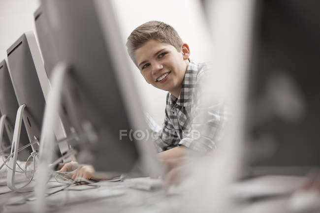 Young person seated working at a terminal — Stock Photo