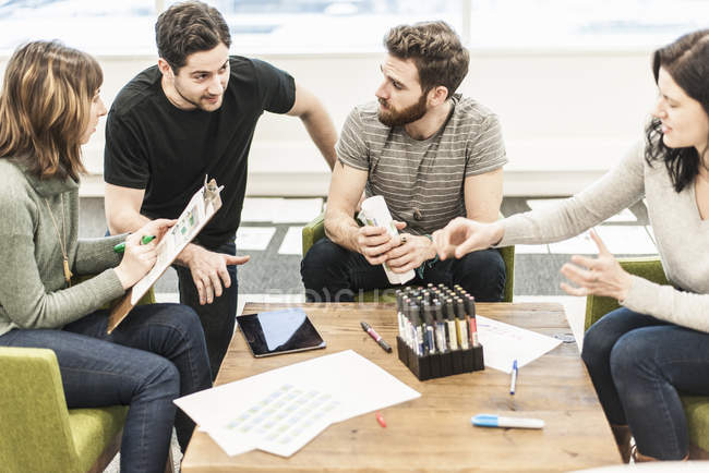 Four people seated at a table — Stock Photo