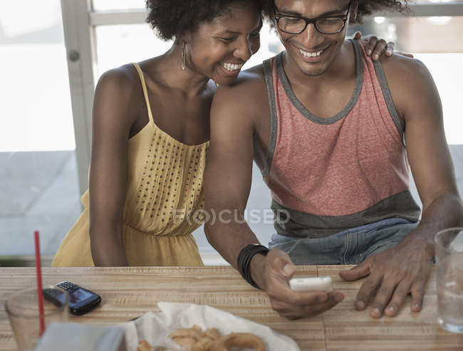 Couple sitting together hugging — Stock Photo