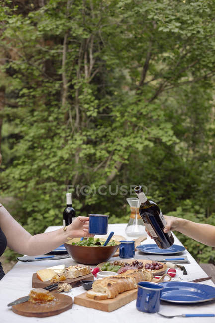 Table in a garden with plates and food — Stock Photo