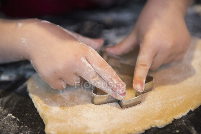 Child making Christmas biscuits — Stock Photo