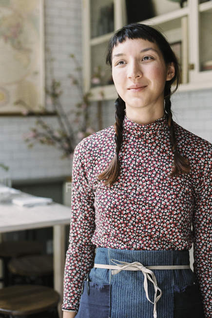 Woman with braids wearing an apron — Stock Photo