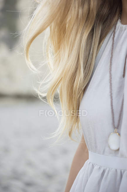 Woman wearing a dress and necklace — Stock Photo