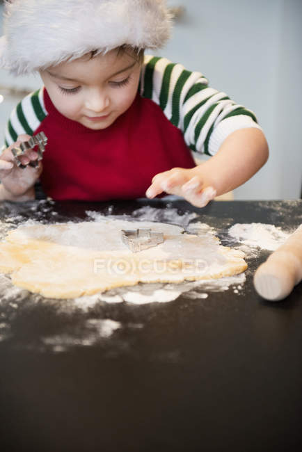 Boy making Christmas biscuits — Stock Photo