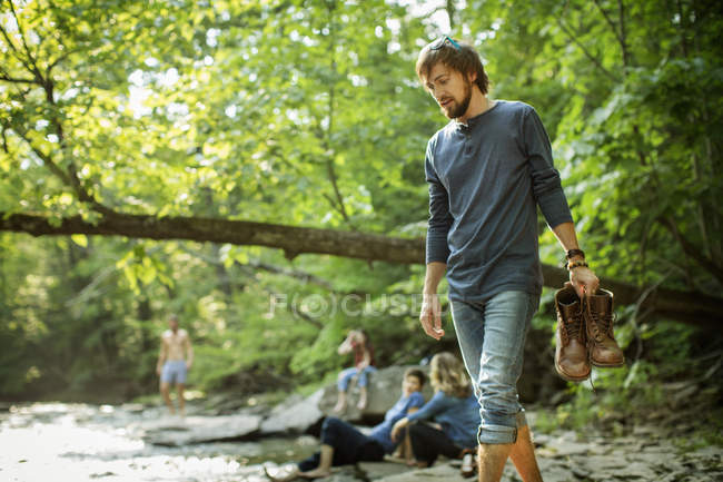 Man carrying his boots — Stock Photo