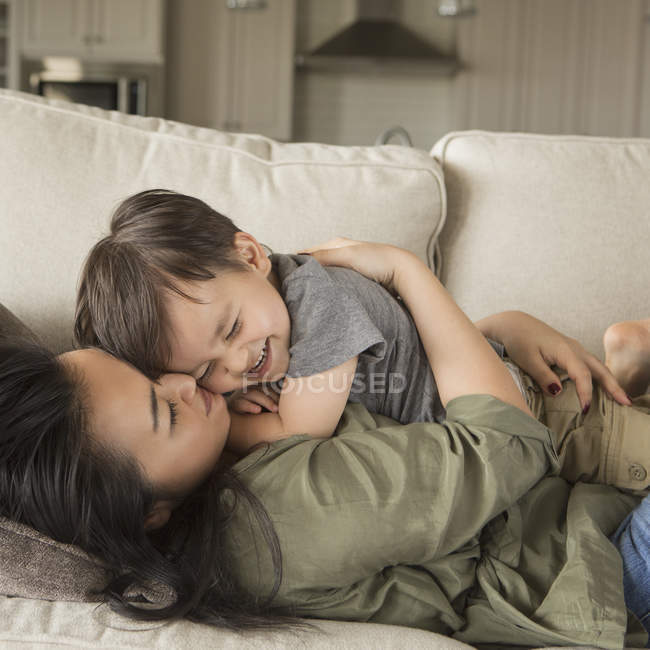 Woman cuddling her young son. — Stock Photo