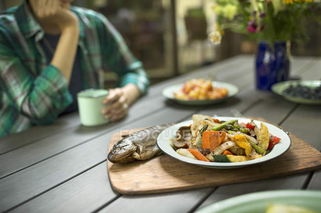 Cooked fresh fish and dish of vegetables. — Stock Photo