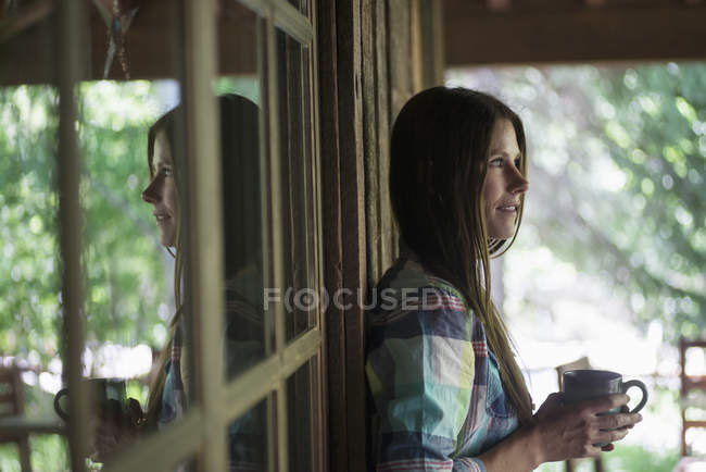 Young woman outside a house — Stock Photo