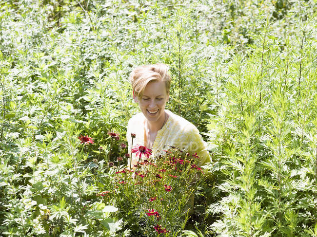 Giovane donna in piedi in un vivaio di piante — Foto stock