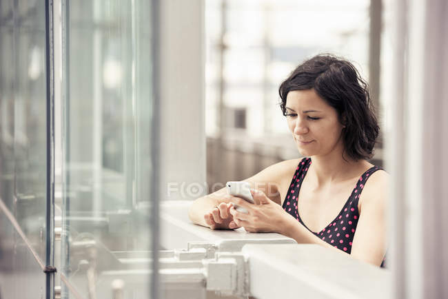 Woman checking her cell phone — Stock Photo