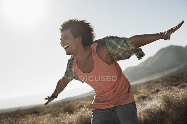 Man with arms outstretched — Stock Photo
