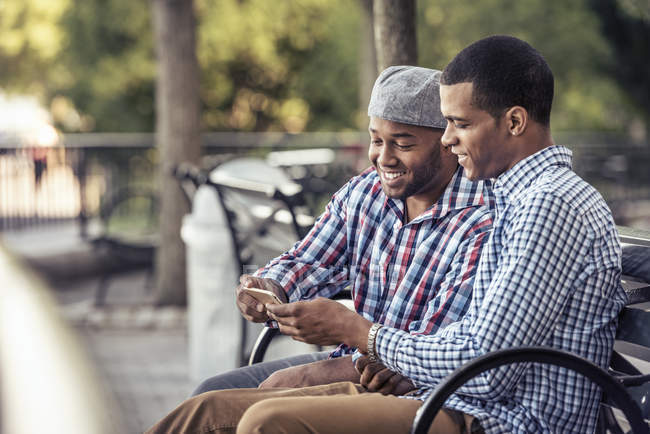 Two men sitting in a park — Stock Photo
