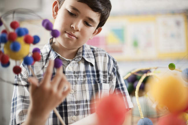 Boy examining a molecular structure — Stock Photo