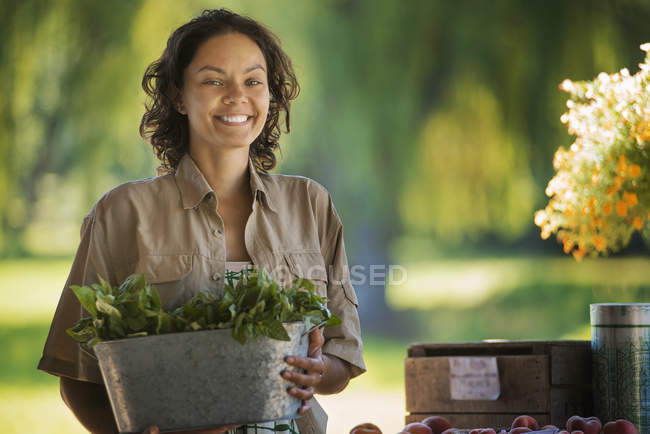 Woman with a large bucket — Stock Photo