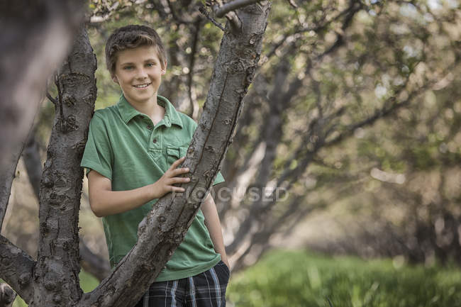 Boy in a woodland tunnel — Stock Photo