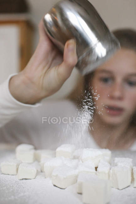 Chica sosteniendo un agitador de azúcar y dragado - foto de stock