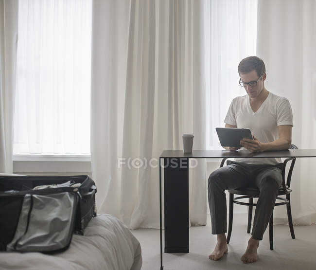 Чоловік працює в спальні готелю . — стокове фото