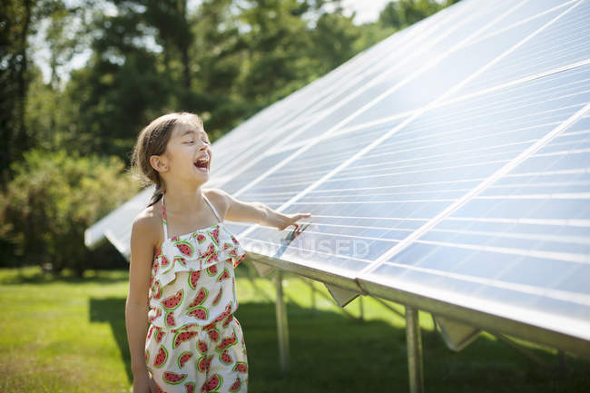 Child beside solar panels — Stock Photo