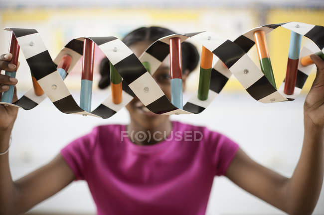 Girl holding a model of a helix structure — Stock Photo