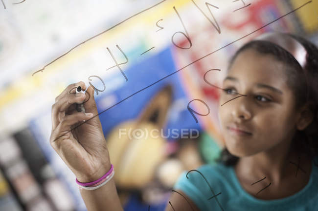 Girl writing with a pen on a board — Stock Photo
