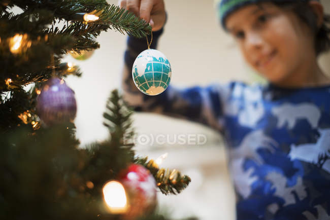 Young boy holding Christmas ornaments — Stock Photo
