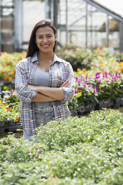 Hispanic woman in greenhouse. — Stock Photo