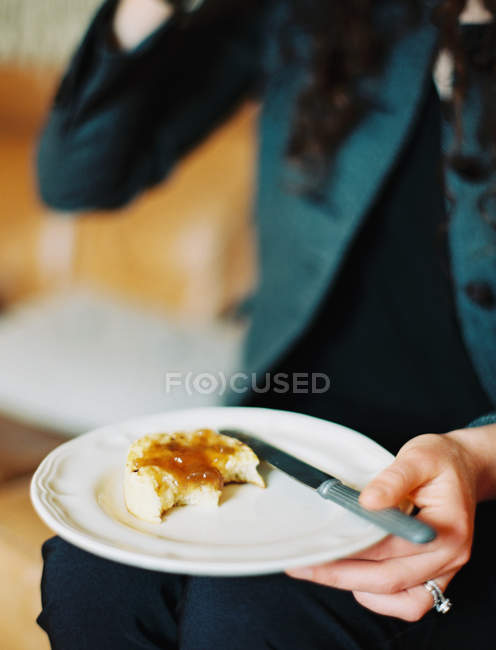 Bollo comido con mermelada en el plato - foto de stock
