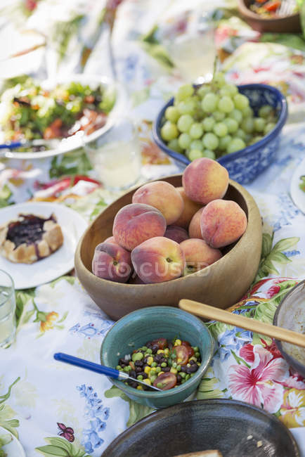 Garden table laid with a buffet of salad — Stock Photo