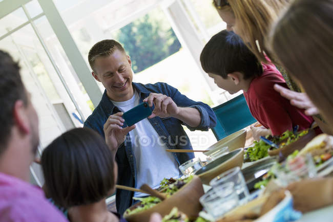 Family party around a table in a cafe. — Stock Photo