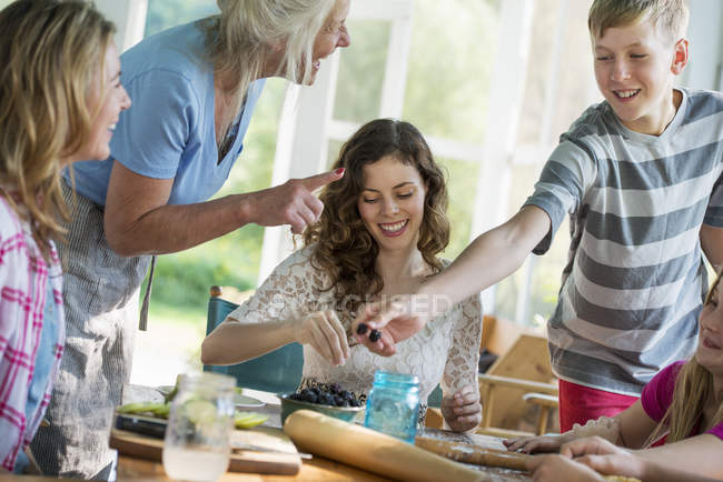 Family baking cookies and apple pie. — Stock Photo