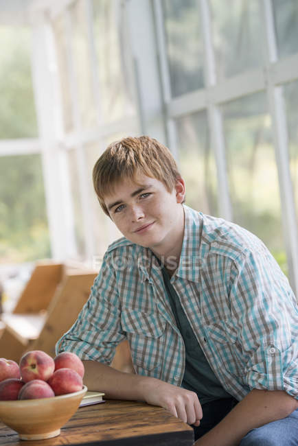 Boy seated at a table. — Stock Photo