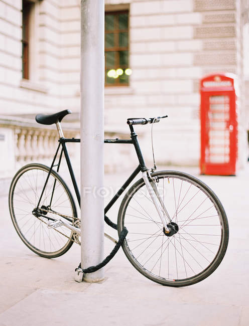 Bicycle chained and locked on a London street. — Stock Photo