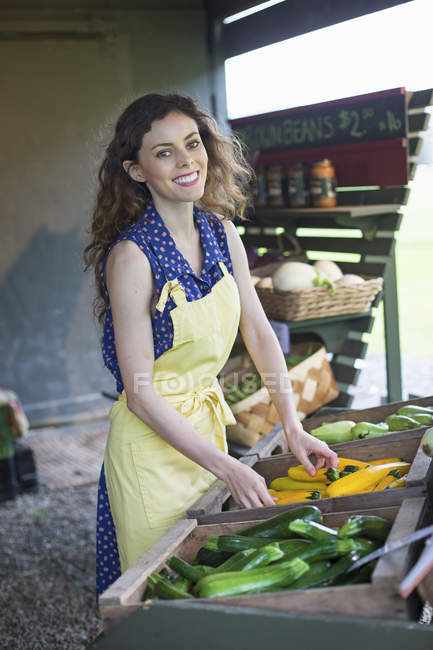 Junge Frau sortiert Zucchini. — Stockfoto