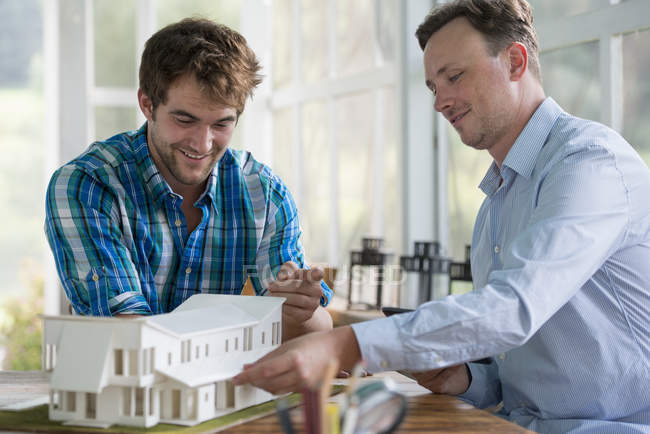 Men looking at an architectural model — Stock Photo