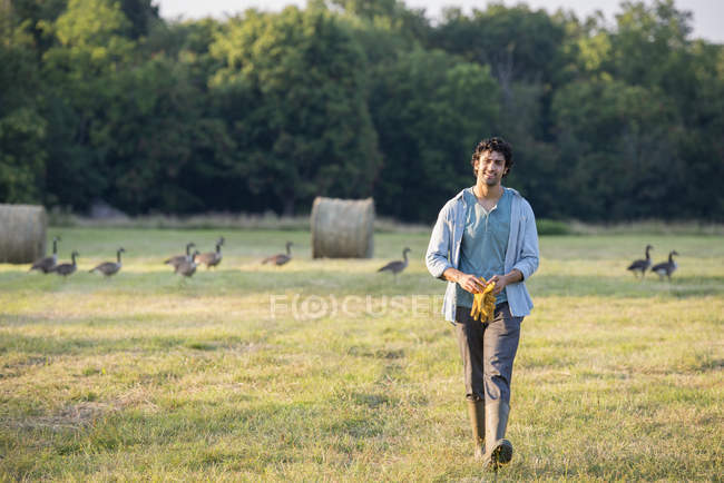 Man walking across field — Stock Photo