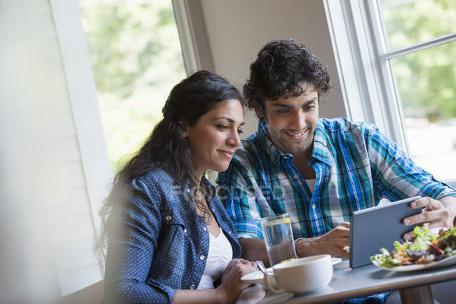 Ouple looking at a digital tablet. — Stock Photo