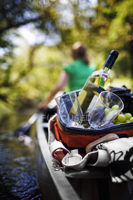 Woman canoeing with picnic — Stock Photo