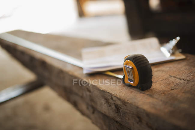 Recycled plank of wood with measuring tape — Stock Photo