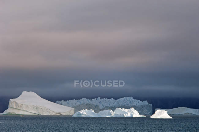 Ciel couchant avec icebergs flottants — Photo de stock