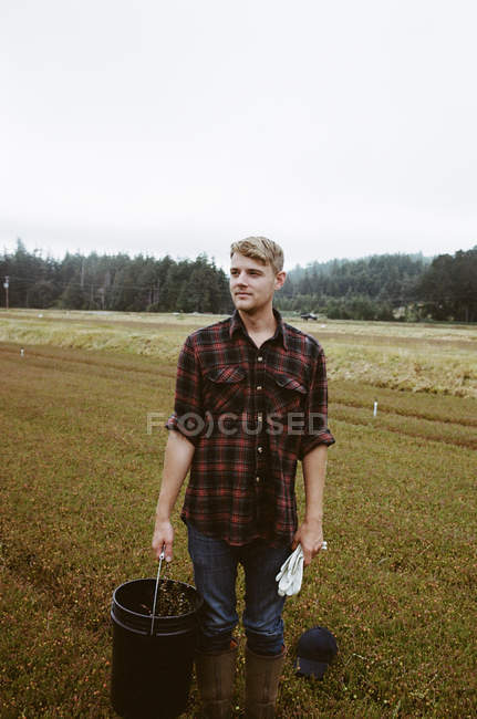Young man working on land — Stock Photo