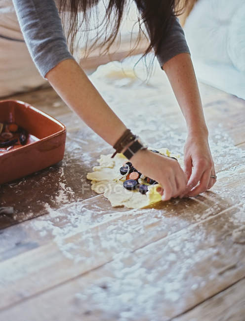 Woman creating an open pastry tart — Stock Photo