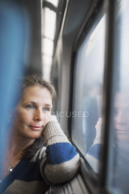 Woman at window seat in train — Stock Photo