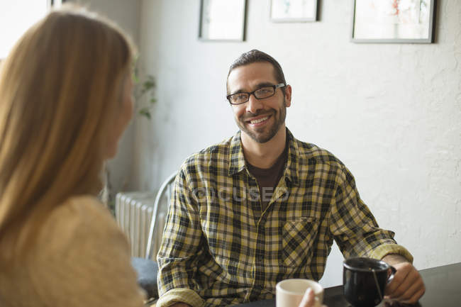 Man and woman talking in cafe — Stock Photo