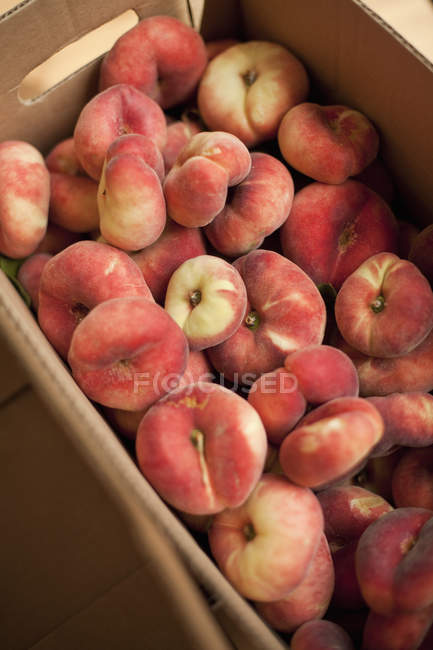 Doughnut peaches in a box. — Stock Photo