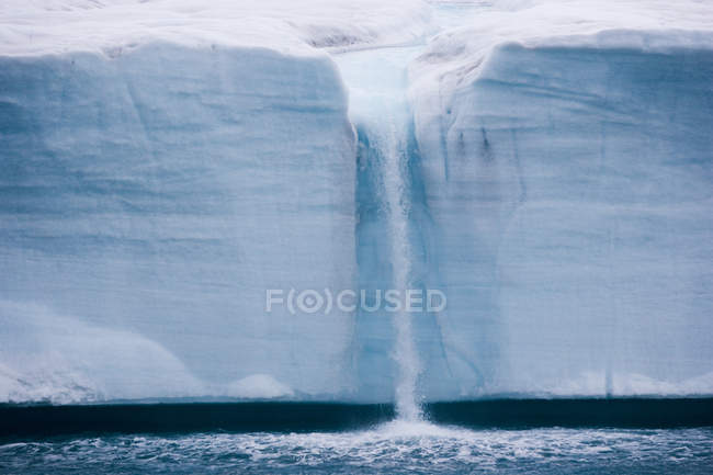 Waterfall created by melting iceberg — Stock Photo